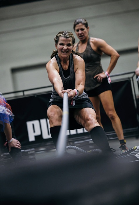 Member pulling battle ropes at a competition